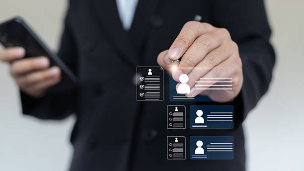 istock A businessman uses a digital interface to select a candidate profile. Concept of online recruitment, resume screening, HR technology, and smart hiring system. 2225072930