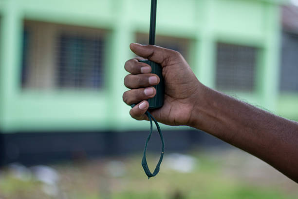 A man is holding an umbrella with his hands and a blurred background