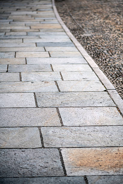 istock Stone sidewalk and cobbleston street 2225073342
