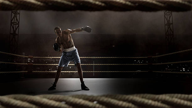 istock Tattooed boxer in defense pose on 3D boxing ring. Boxing event campaigns 2225074146