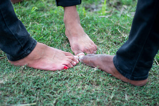 Three boys with their feet on the grass