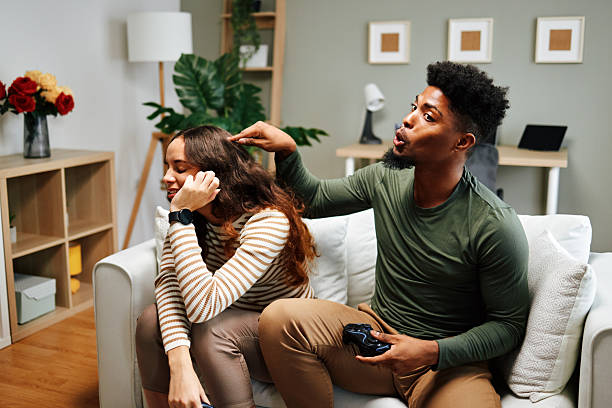 istock Boyfriend distracting girlfriend while playing videogames at home 2225075218