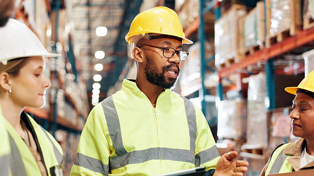 istock Man, tablet and group for logistics at warehouse for talk with clipboard, planning or inventory management. Plant supervisor, team and meeting with strategy for supply chain, distribution or shipping 2225078030