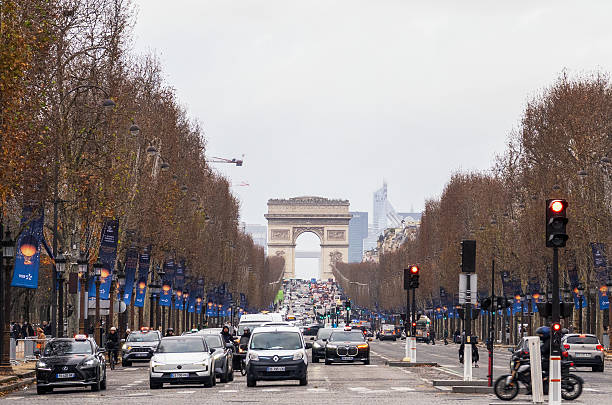 Paris, France - Heavy traffic on the Avenue des Champs-Elysees in central Paris, with the Arc de Triomphe on the horizon.