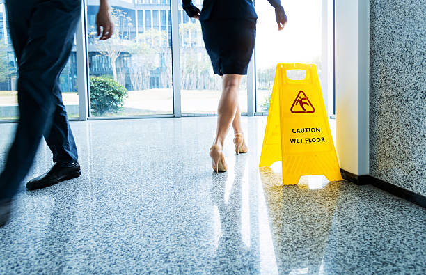 istock Caution wet floor sign with motion blurred legs walking 2225082200