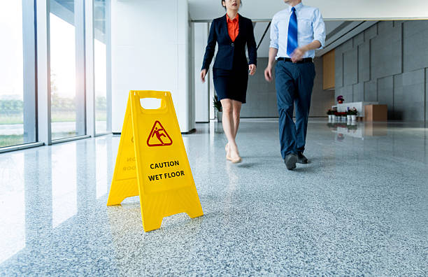 istock Caution wet floor sign with businessmen walking 2225082201