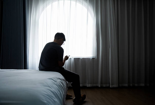 istock Teenager boy sitting on bed using mobile phone 2225082685