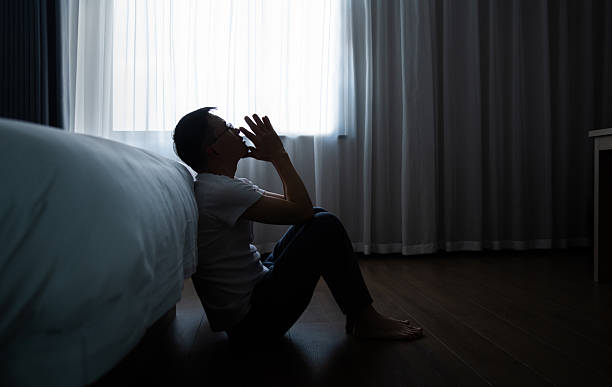 istock Depressed man sitting on bedroom floor 2225082772