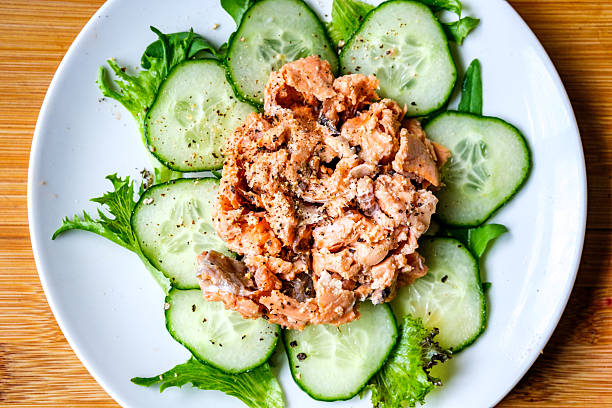 London UK, July 14 2025, Red Salmon Fish With Cucumber and Salad Leaves