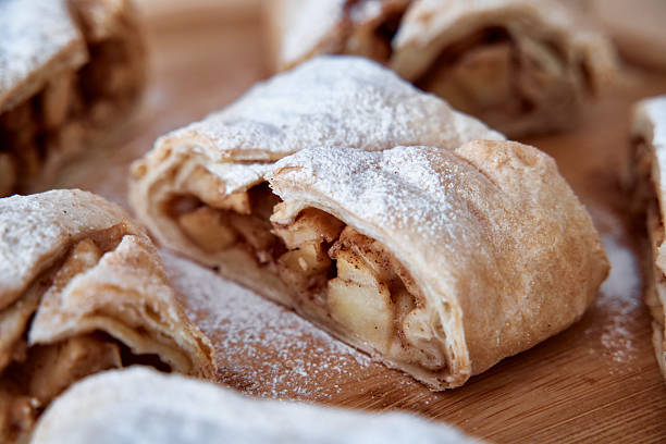 istock Delicious apple strudel with cinnamon and sugar on wooden board 2225084238