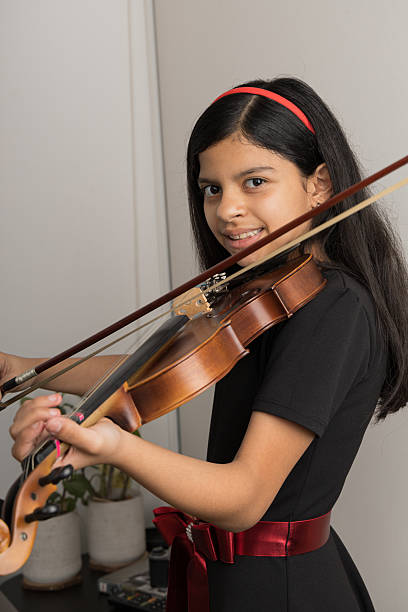 istock A young girl is playing the violin 2225085657