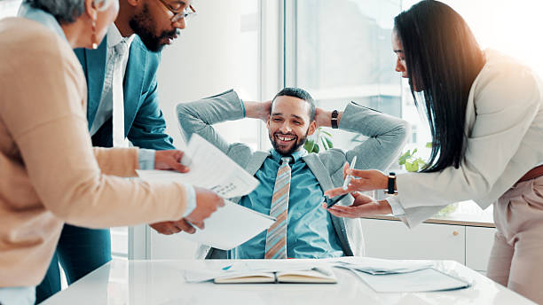 istock Businessman, multitasking and happy with group, documents at office, relief and time management. Person, team and relax with notes, report and signature for approval with smile at finance agency 2225086693
