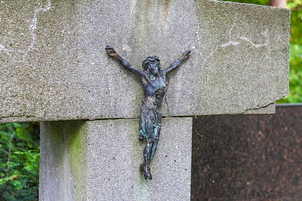 istock Bronze crucifix sculpture mounted on stone memorial creating powerful religious symbol 2225086831