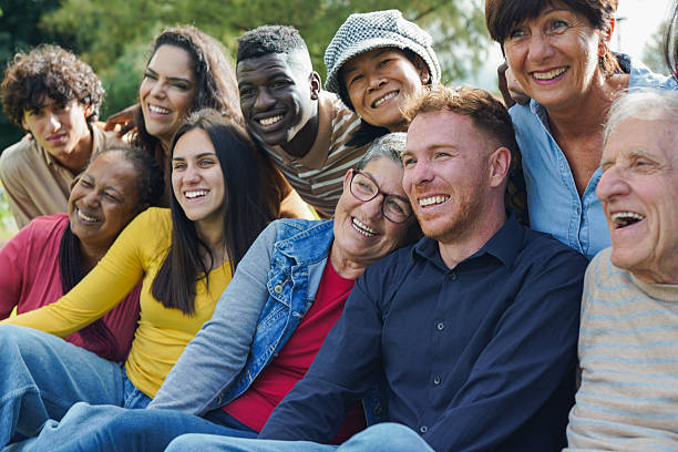 istock Group of multiracial people having fun hugging each other at city park - Diversity, multi generational friends and community concept 2225088782