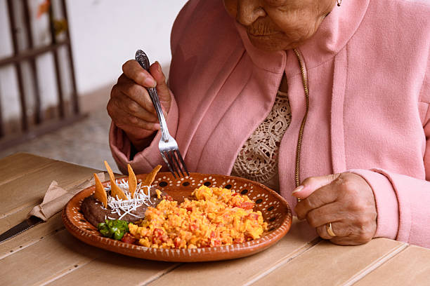 istock Elderly Mexican woman eating scrambled eggs 2225091571