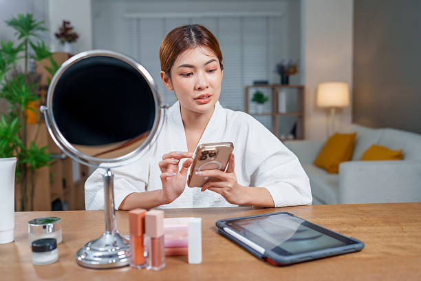 istock A young woman is learning how to apply her make-up on social media on her device. 2225093449
