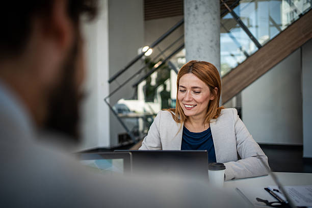 istock Businesswoman smiling while working on laptop in modern office 2225094929