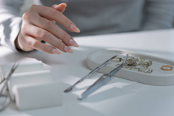 istock Delicate feminine hand with subtle manicure in salon setting, 2225095022