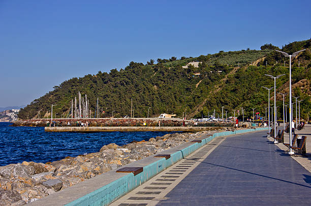 Bursa, Turkey - July 5, 2025: Tirilye or zeytinbağı located in mudanya bursa is an old town inhabited since the eighth century BC. You see the people visited this town in summer time. There are restaurants, souvenir shops and old houses near marmara sea.