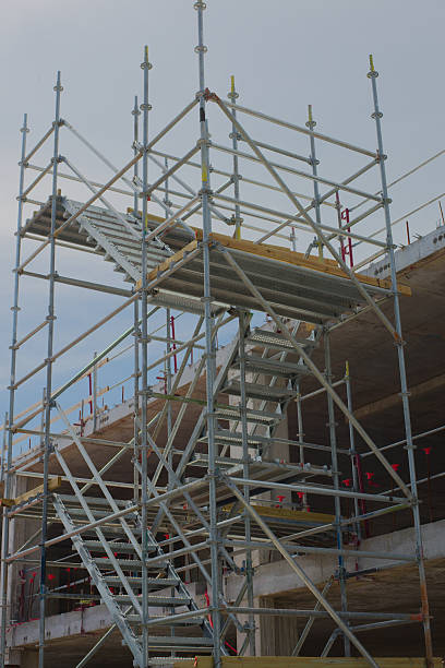 istock Construction of a Multi-Level Structure Featuring Scaffolding and Safety Measures 2225098077