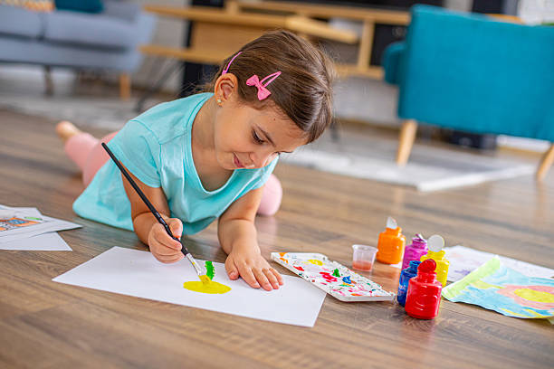 istock Cute girl creating artwork at home, enjoying a creative activity 2225100575