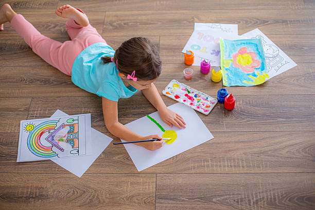 istock Cute girl creating artwork at home, enjoying a creative activity 2225100585