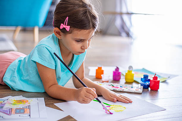 istock Cute girl creating artwork at home, enjoying a creative activity 2225100600