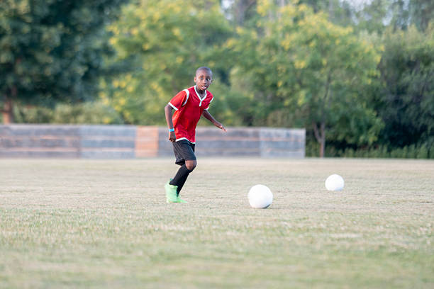 istock Young Soccer Player Practicing on a Field in Bright Daylight 2225101542