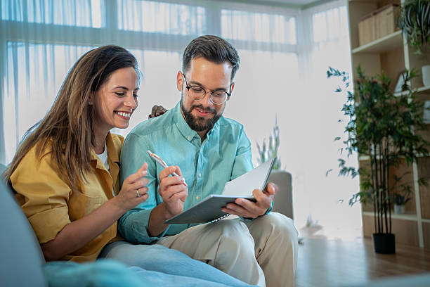 istock Couple reading documents and planning finances at home 2225102285