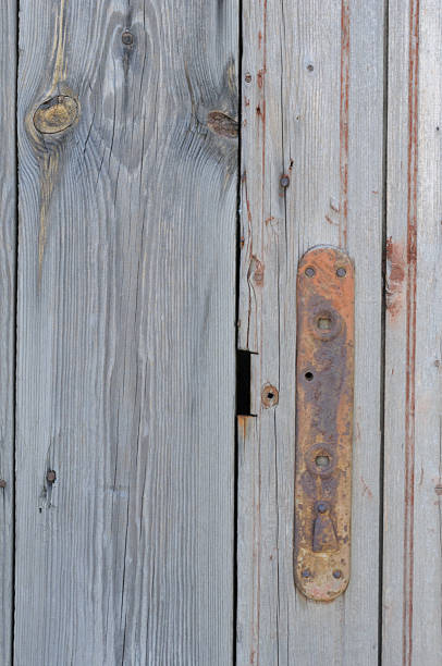 istock Old wooden door with rusty metal handle. 2225103053