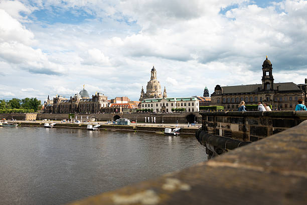Dresden Frauenkirche and old town buildings from the Augustus Bridge. Historic landmarks in the cityscape and the Elbe river. Sightseeing and tourism in Saxony.