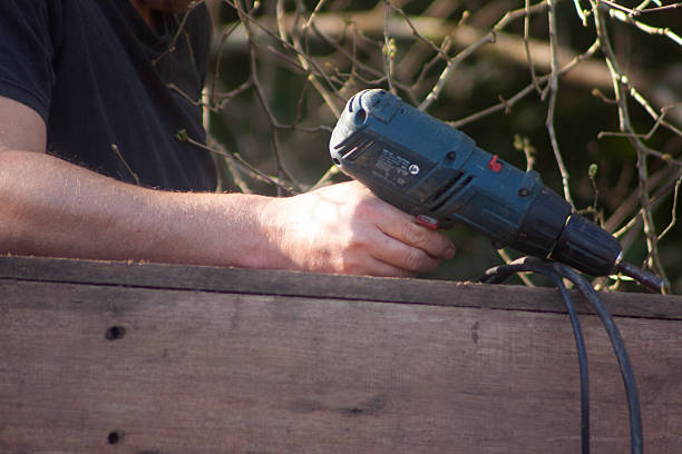 istock man building his own shack with tools 2225107263