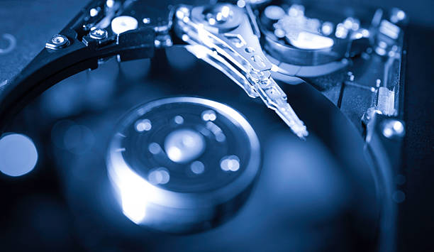 istock Close up of a computer hard drive showing internal mechanics and components in blue light during a data storage process 2225107441
