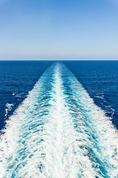 istock Calm blue ocean with wake pattern created by boat cruising in clear sky on sunny day 2225108094