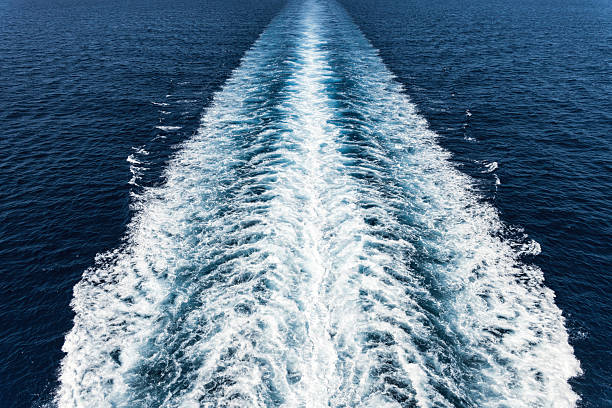 istock Water trails created by a boat moving across the open ocean on a clear sunny day 2225108154