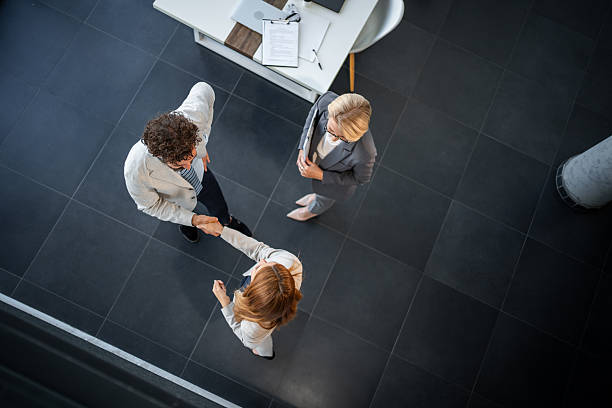 istock Business people shaking hands in modern office lobby 2225108207