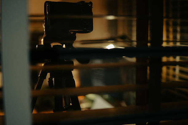 istock Warm Cinematic Desk Setup Viewed Through Window Blinds at Night 2225108431