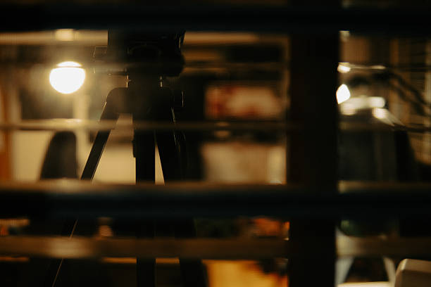 istock Warm Cinematic Desk Setup Viewed Through Window Blinds at Night 2225108515