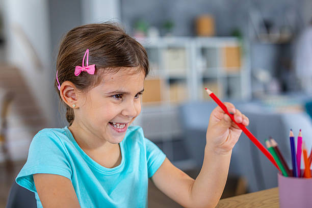 istock Cute girl creating artwork at home, enjoying a creative activity 2225108700