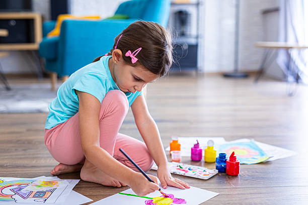 istock Focused young child drawing shapes and patterns at home 2225108943