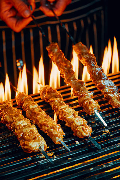 Chicken Skewers on BBQ Grill with Open Flames