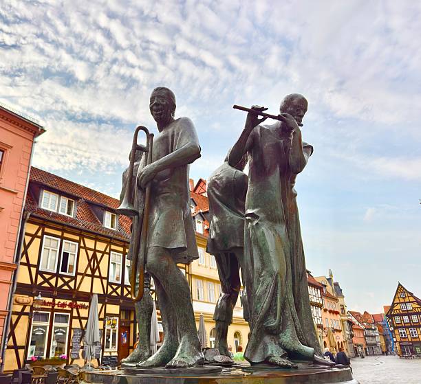 Quedlinburg, Germany: July 14, 2025 - This monument has been in the market square since 1976. It shows four Munzberg musicians who were formerly inhabitants of Bohemian descent on the Munzenberg hill opposite castle hill.The people earned an  income by making music.\nThe group of bronze figures is now in the middle is a fountain. The artist was Wolfgang Dreysse