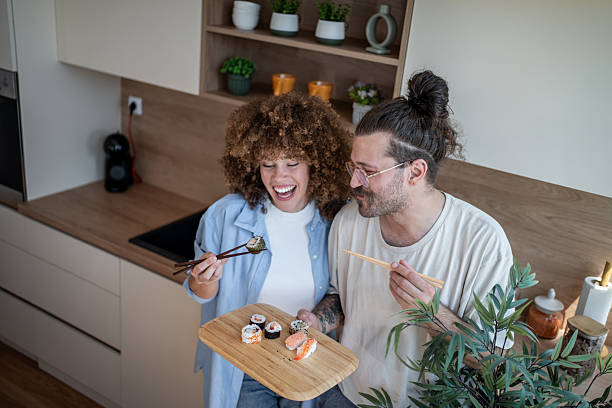 istock Happy couple enjoying sushi in modern kitchen 2225112505