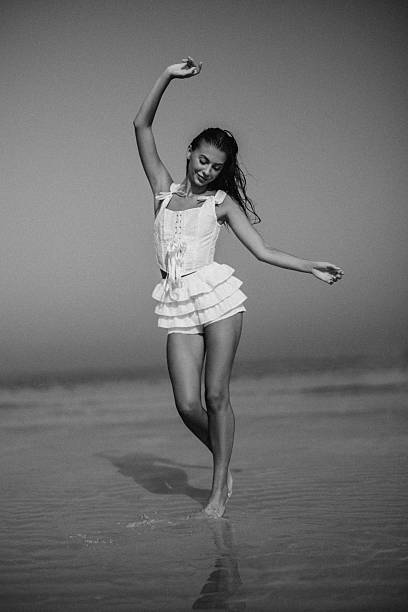 istock Woman dancing gracefully on a beach in black and white 2225114039