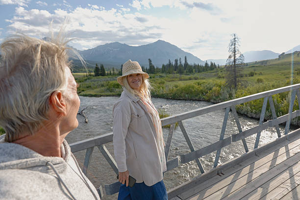 istock Mature couple on bridge above river and wetlands 2225114071