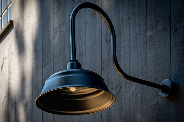 Modern Gooseneck Barn Light on Vertical Wood Siding Wall at Dusk