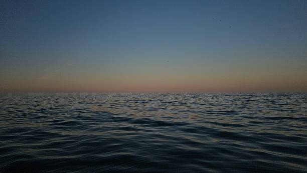 istock Tranquil Sunset Over Calm Ocean Waters Sunset over the sea 2225117352