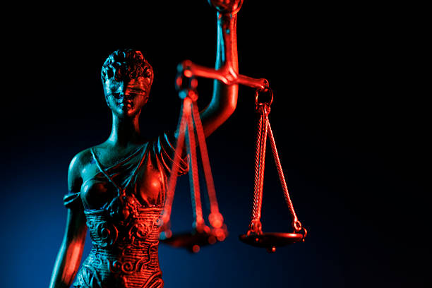 istock Lady Justice statue symbolizing fairness and equality with a dramatic red lighting 2225119158