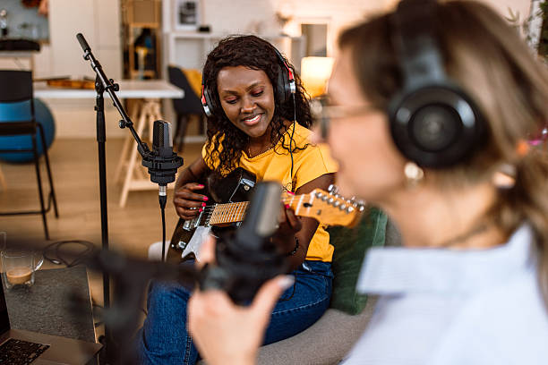istock Woman playing guitar live in podcast 2225121679