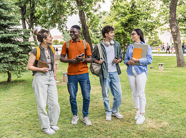 istock Cheerful university students talking together outdoors in a park 2225122713